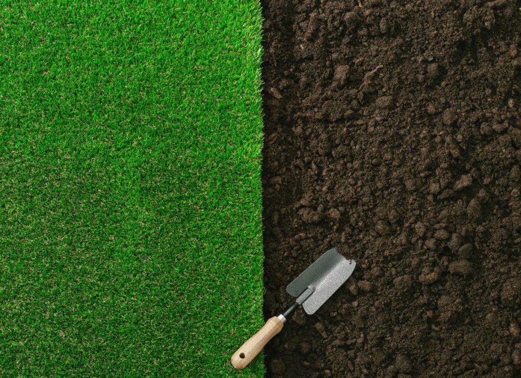 shovel in grass and soil