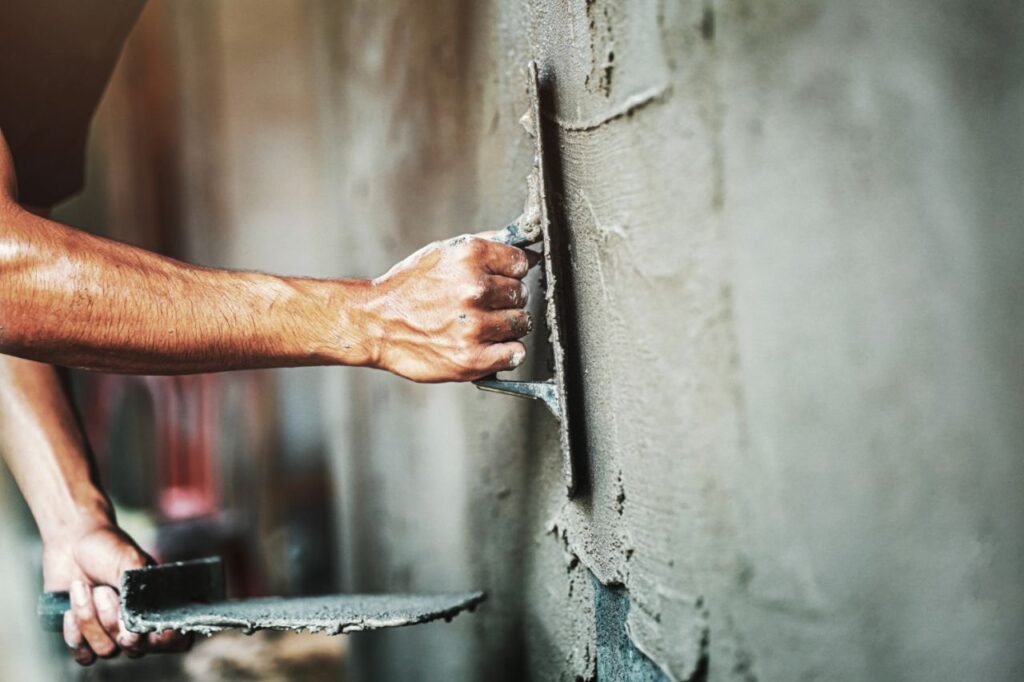 closeup-hand-worker-plastering-cement-wall-building-house